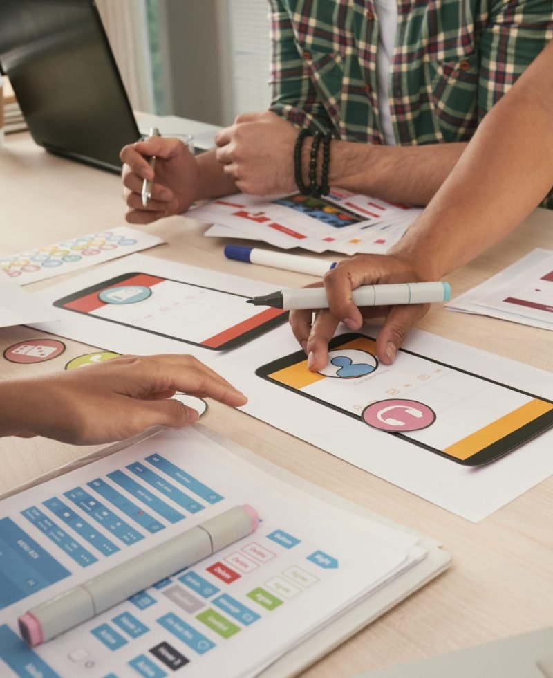 Close-up image of business team choosing icons for new mobile applications