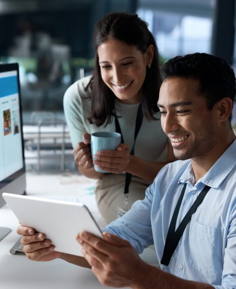 Shot of a young businessman and businesswoman using a digital tablet in a modern office.